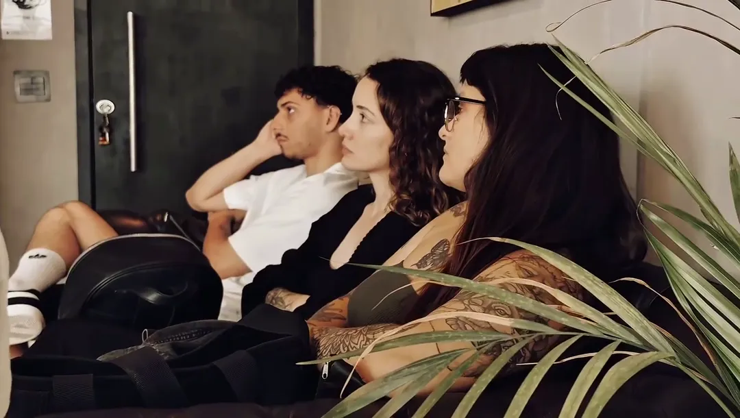 Artistas da BZINK sentados no sofá do estúdio durante uma reunião
